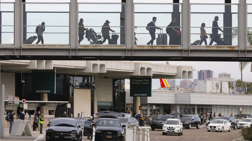 Travelers cross the sky bridge at San Diego International Airport.