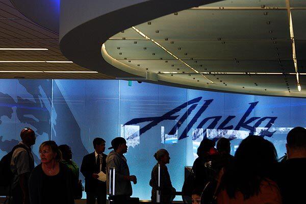 Passengers wait to check in at Alaska Airlines' newly remodeled home at LAX, Terminal 6. The remodel includes a variety of improvements to bag check, ticketing, security screening, waiting areas at gates and more.