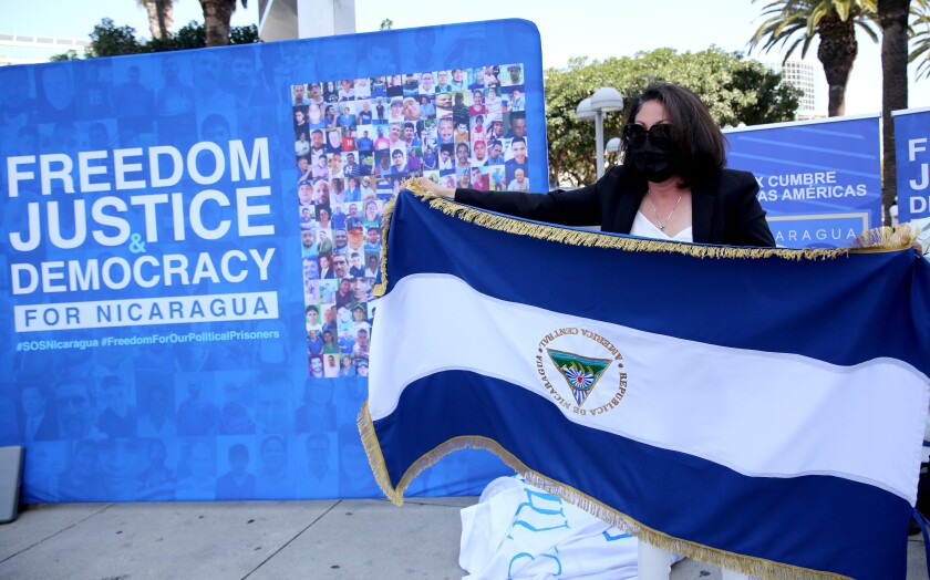 Nicaraguan activist Fidelina Alvarez holds a Nicaraguan flag upside down as civil disobedience