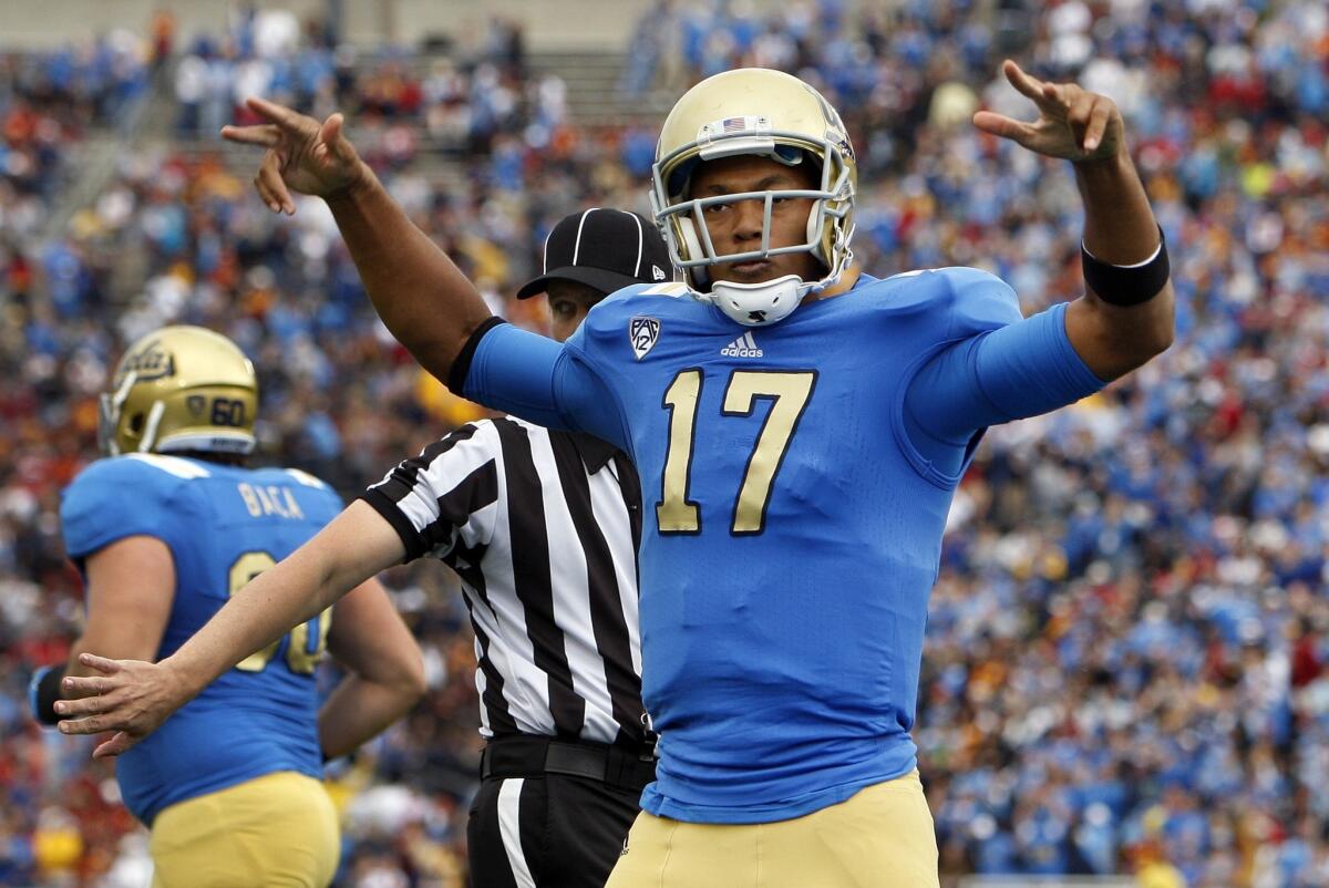 UCLA quarterback Brett Hundley celebrates after scoring a touchdown against USC last year. Hundley knows Bruins fans are expecting a win over the Trojans on Saturday.