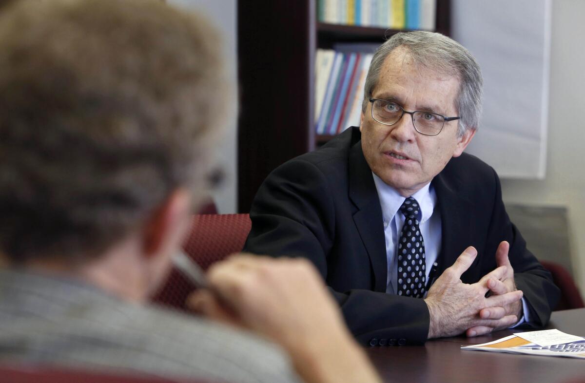 Legislative Analyst Mac Taylor, right, answers a reporter's question concerning his office's assessment of Gov. Jerry Brown's updated budget during a news conference in Sacramento.