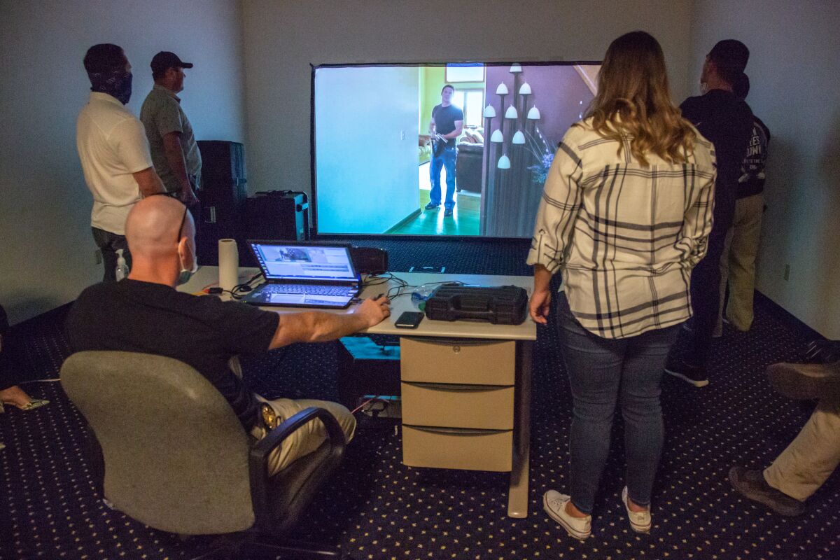 San Diego police officers take part in a de-escalation training course that utilizes interactive video scenarios on Friday. 