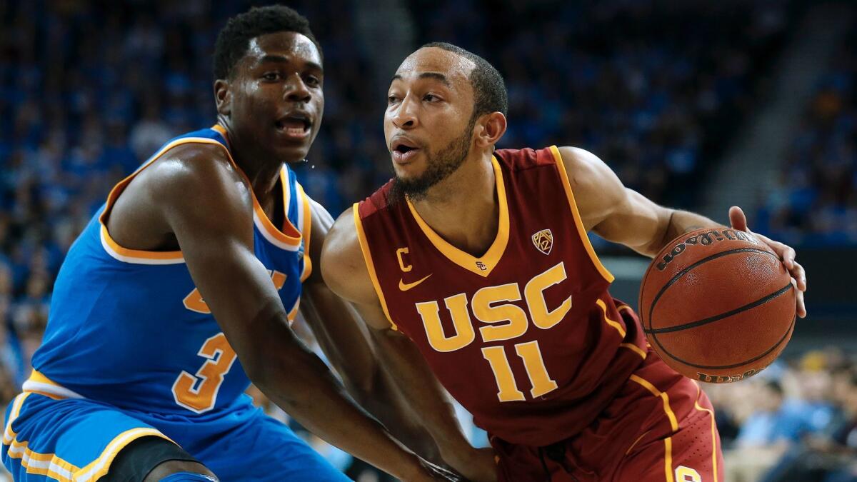 USC guard Jordan McLaughlin, left, is guarded by UCLA guard Aaron Holiday on Feb. 18, 2016.