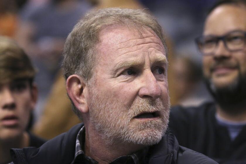 FILE - In this Dec. 11, 2019, file photo, Phoenix Suns owner Robert Sarver watches the team play against the Memphis Grizzlies during the second half of an NBA basketball game in Phoenix. The Suns released a statement regarding a potential media investigation into the workplace culture of the franchise, denying that the organization or Sarver has a history of racism or sexism. The statement sent Friday, Oct. 22, 2021, said the organization is aware that ESPN is working on a story accusing the organization of misconduct on a “variety of topics.” The Suns responded by saying they were “completely baseless claims” and “documentary evidence in our possession and eyewitness accounts directly contradict the reporter’s accusations, and we are preparing our response to his questions.” (AP Photo/Ross D. Franklin, File)