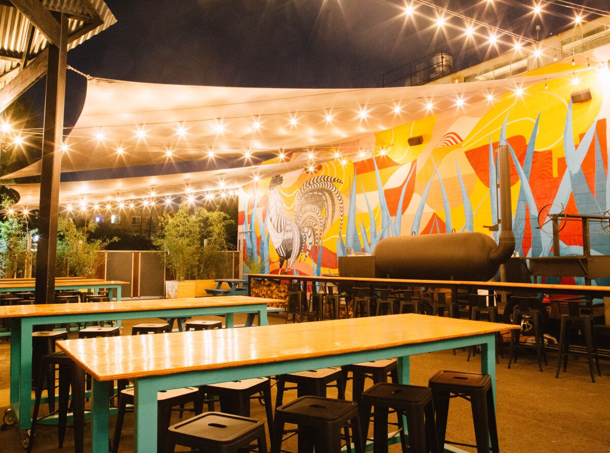 Market lights, colorful murals and more accent Sideyard BBQ by HottMess.