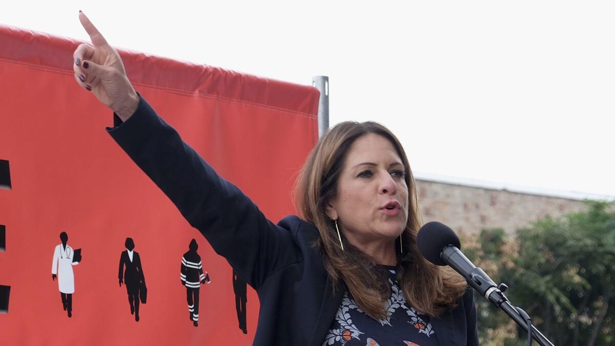 Producer Cathy Schulman speaks at the Take Back the Workplace March in Hollywood.