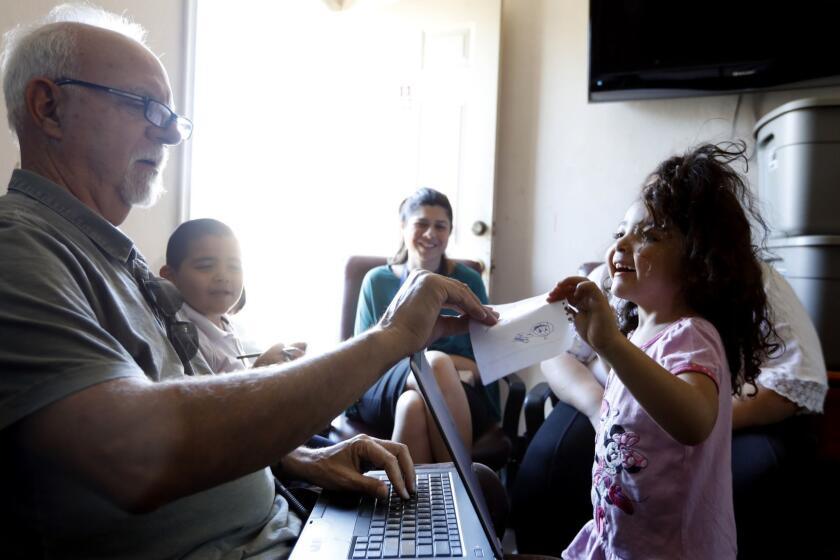 PACOIMA, CA OCTOBER 16, 2018: Los Angeles Times Columnist Steve Lopez, left, interviews a family in a motel room in Pacoima, CA October 4, 2018. He is always kind and engaging with children. He is sharing paper and pens with the children as their parents are being interviewed. Sophia, 4, right, and her family are currently staying this motel operated by LA Family Housing in Pacoima, CA. (Francine Orr/ Los Angeles Times)