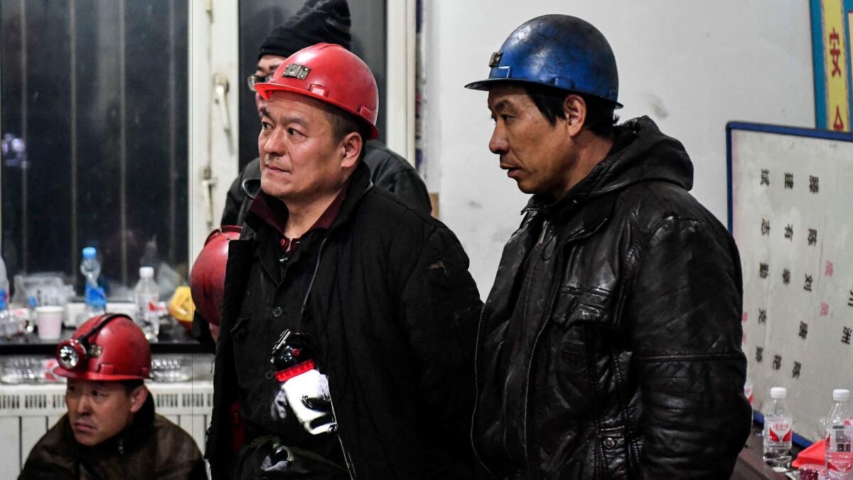 Rescuers and workers attend a briefing Wednesday before searching for workers trapped in a coal mine in Qitaihe City, northeast China's Heilongjiang province.