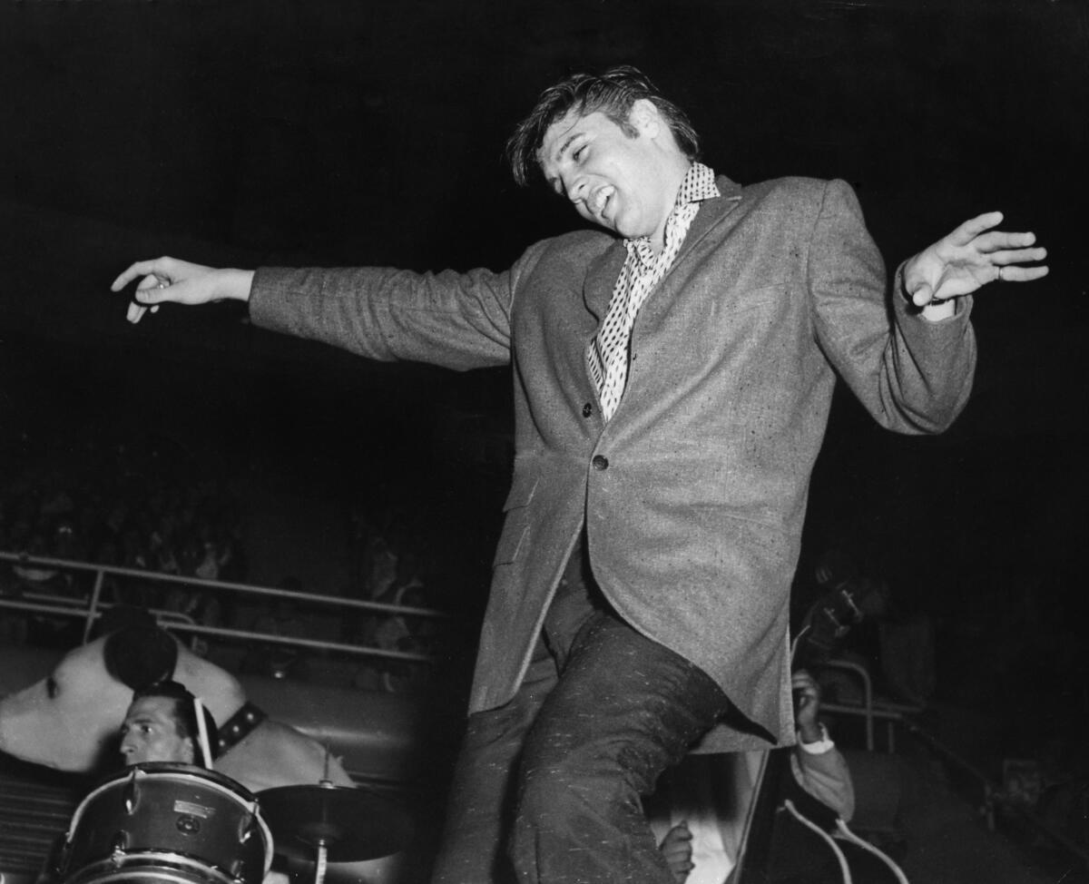 A young man performs onstage.