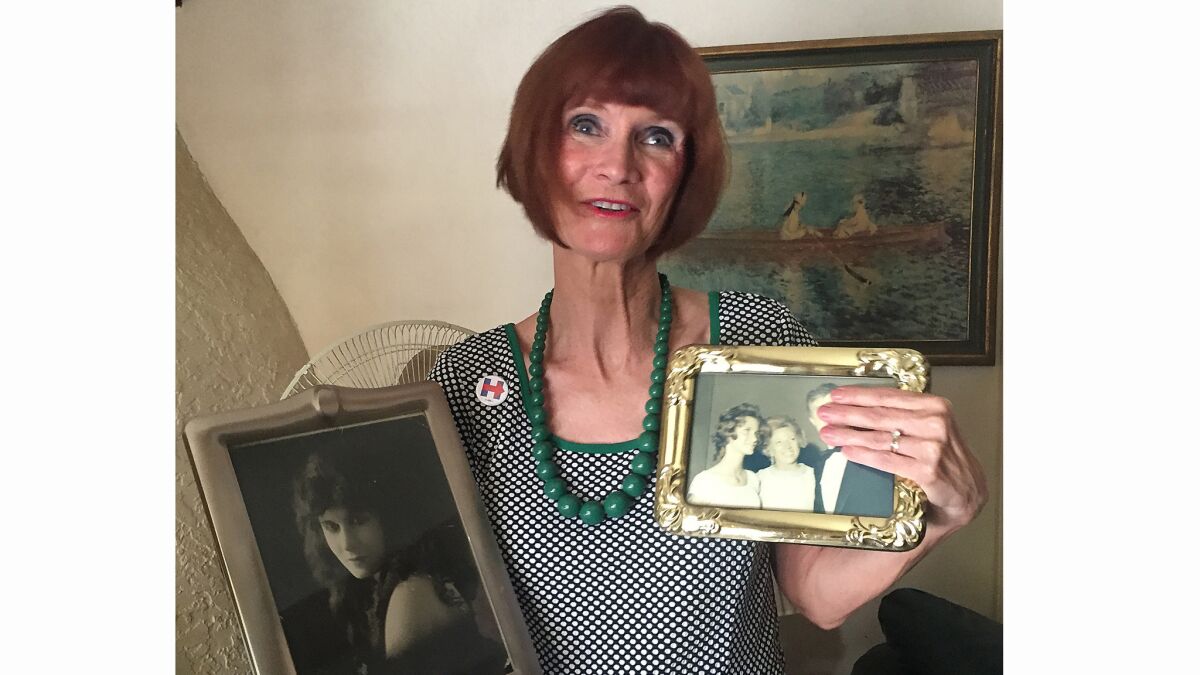 Celeste Pettijohn, with photos of her grandmother, silent film actress Belle Bruce, and of her parents.