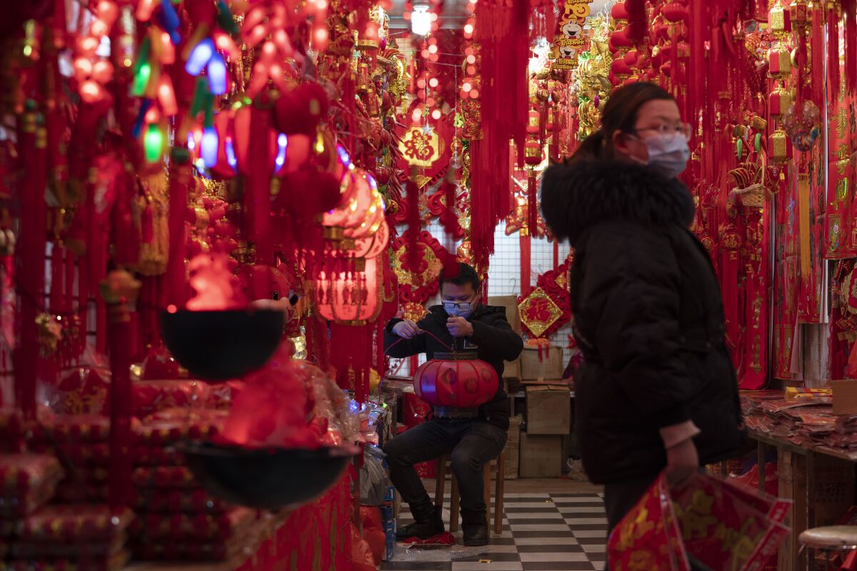 Decorations for the Chinese New Year hang in a store in Wuhan.