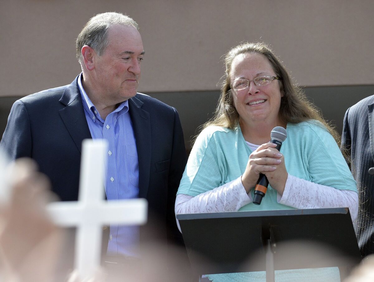 Rowan County Clerk Kim Davis, with Republican presidential candidate Mike Huckabee, left, at her side, speaks after being released from the Carter County Detention Center in Grayson, Ky., on Tuesday.