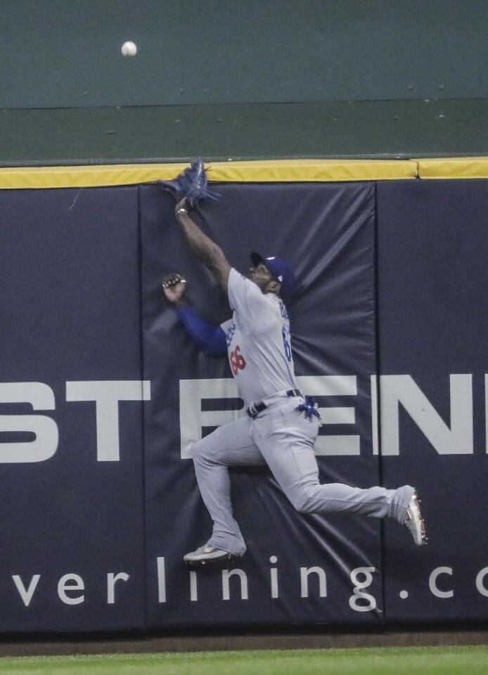 Yasiel Puig can’t reach a first inning homer by Christian Yelich.