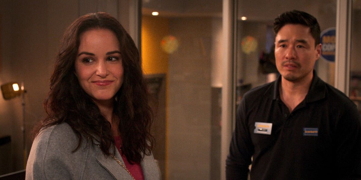 Actors Melissa Fumero as Eliza, and Randall Park as Timmy in a scene from "Blockbuster."