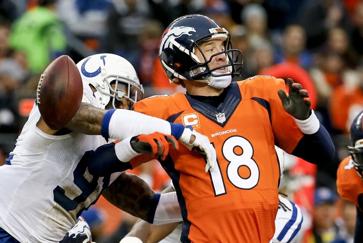 Colts linebacker Jonathan Newsome forces Broncos quarterback Peyton Manning to fumble as he attempts a pass in the first half Sunday.