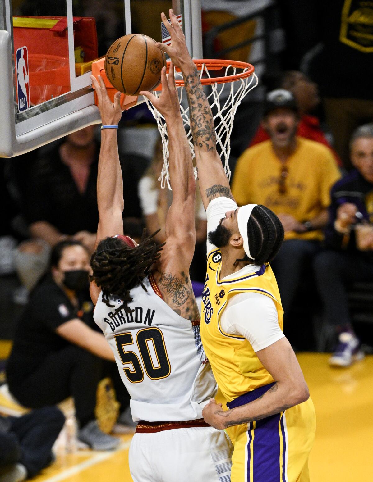Lakers forward Anthony Davis, right, blocks a shot by Nuggets forward Aaron Gordon at the rim.