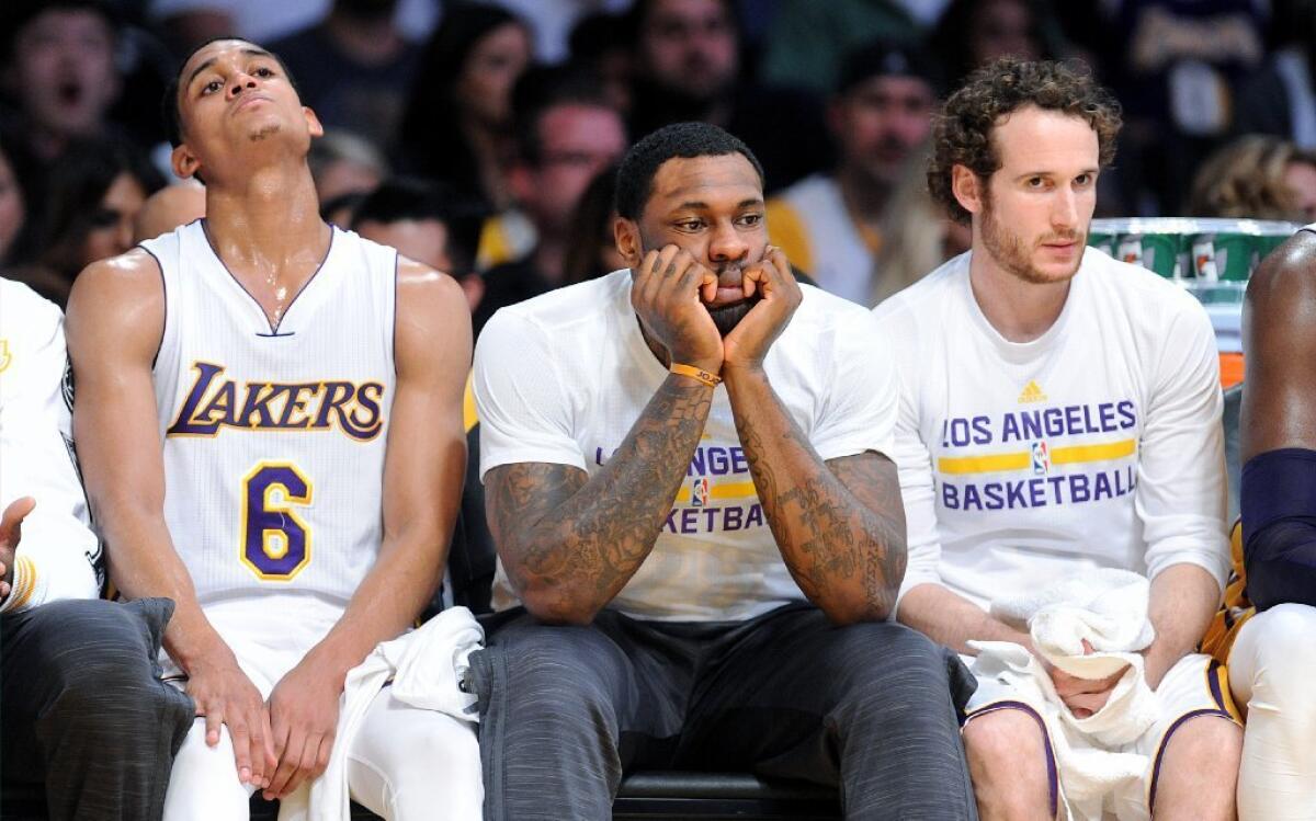 Lakers Jordan Clarkson (6), Tarik Black, center, and Marcelo Huertas sit on the bench during a blowout loss to the Rockets on Jan. 17, 2016.