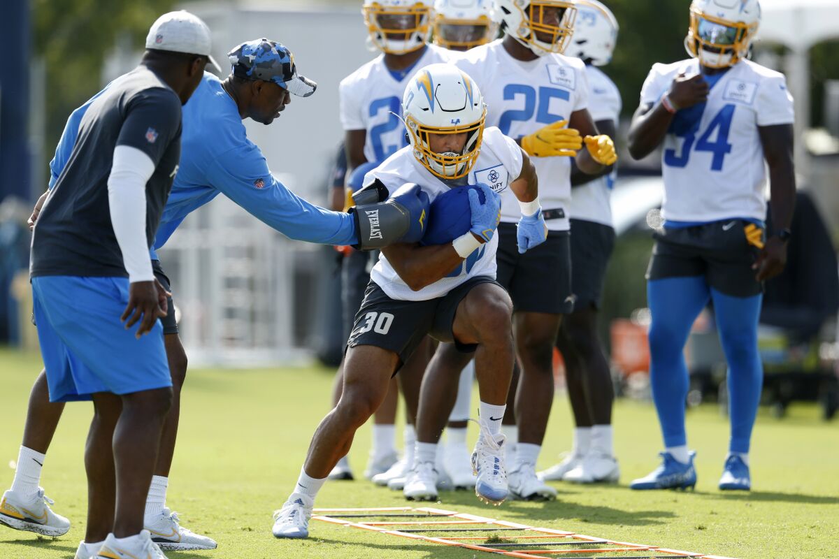 Chargers running back Austin Ekeler (30) runs with the football during drills.