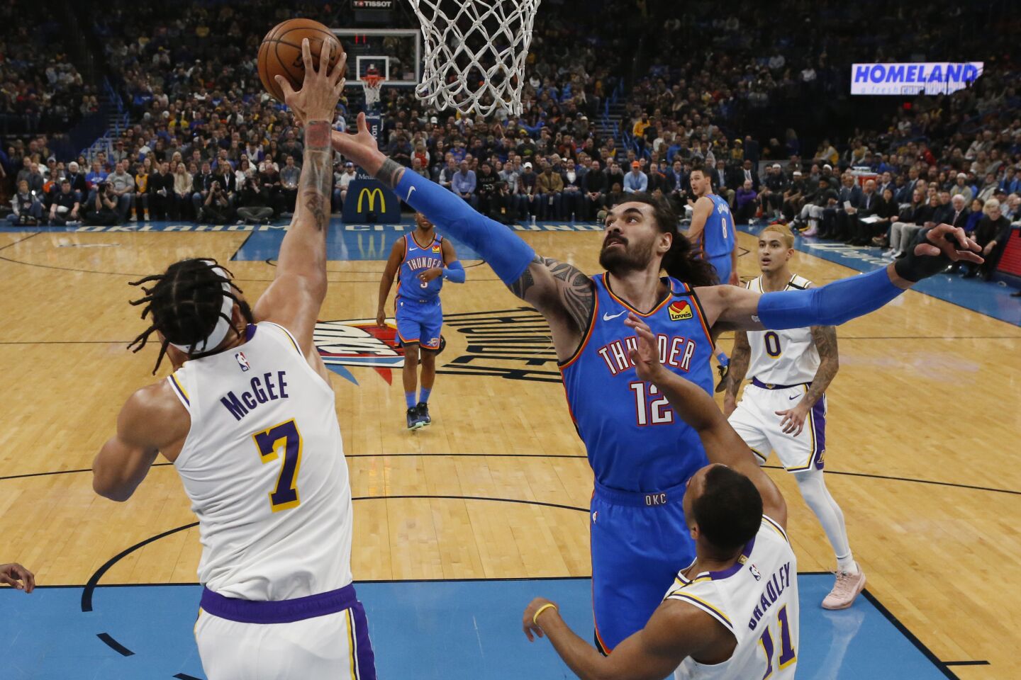 Thunder center Steven Adams (12) and Lakers center JaVale McGee (7) reach for a rebound during the first half of a game Jan. 11.