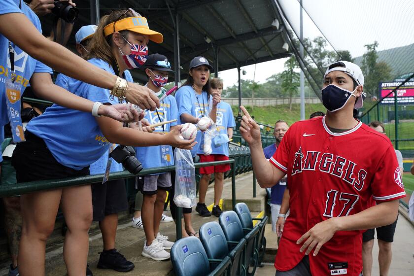 Los Angeles Angels' Shohei Ohtani (17) signs autographs for parents of the Honolulu, Hawaii Little League team as he arrives at Lamade Stadium during a weather delay in a a baseball game between Honolulu, Hawaii and Hastings, Neb. at the Little League World Series in South Williamsport, Pa., Sunday, Aug. 22, 2021. The Los Angeles Angels play the Cleveland Indians in the Little League World Series Classic in Williamsport, Pa, Sunday night. (AP Photo/Gene J. Puskar)