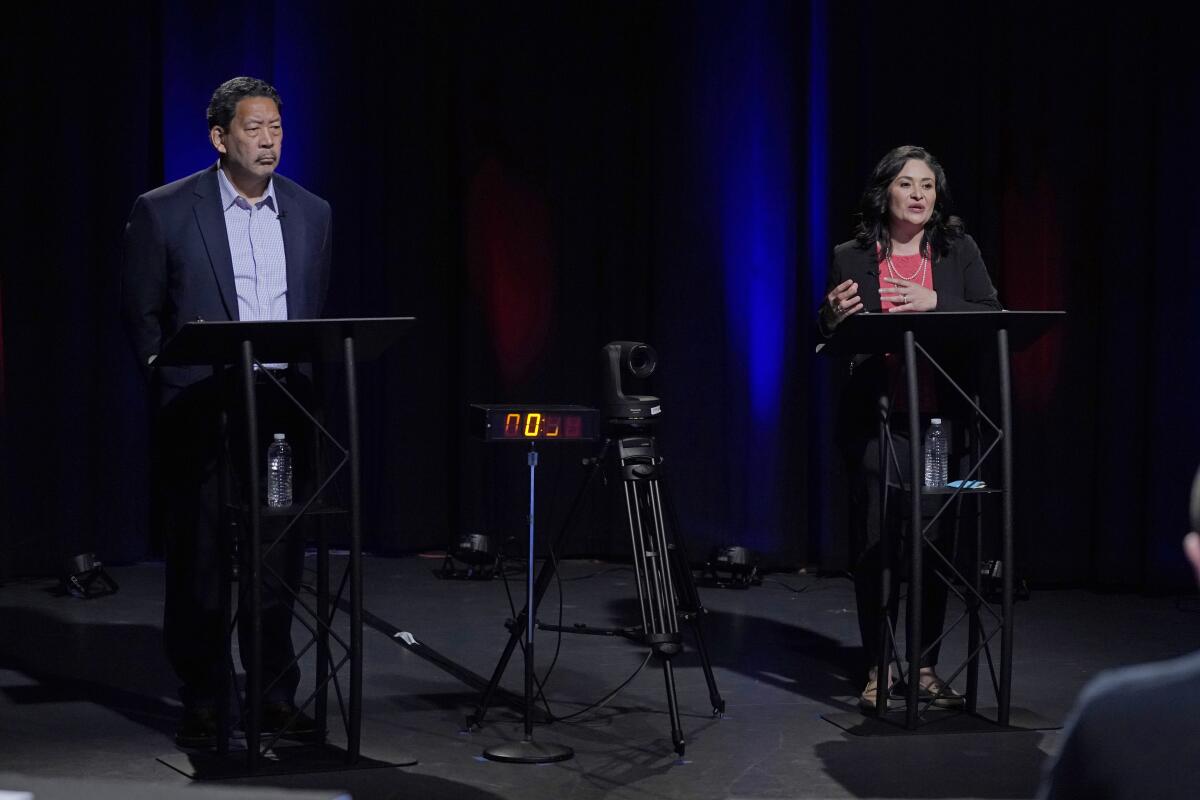  Two people stand behind lecterns.