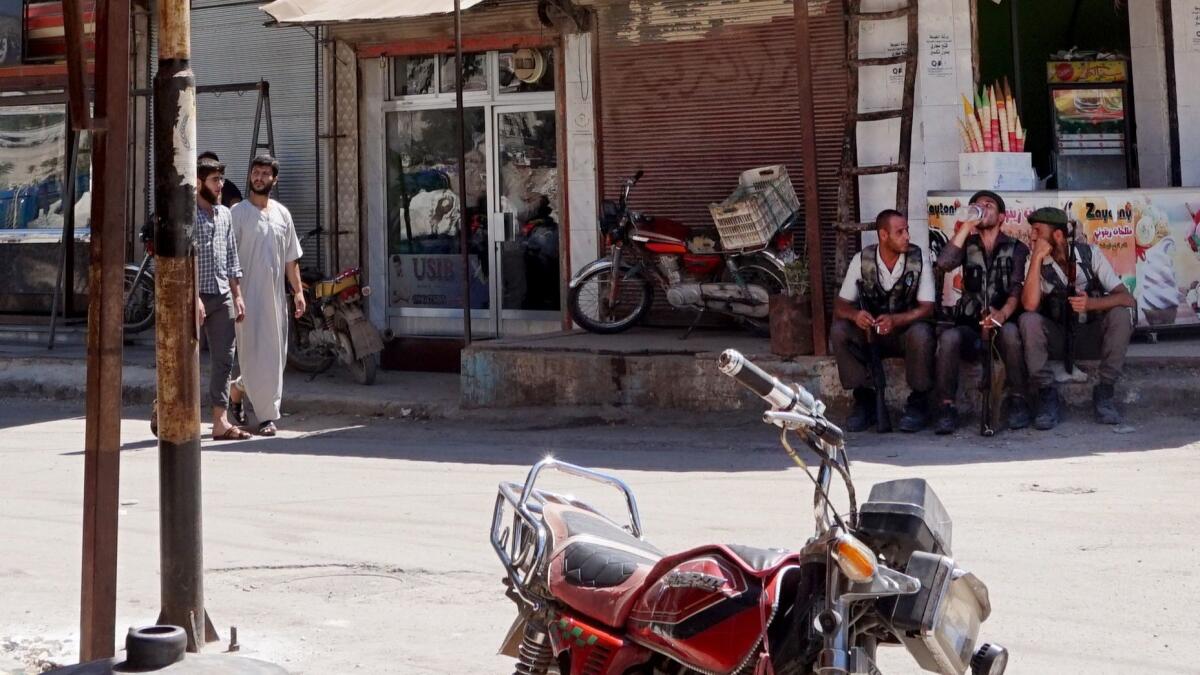 Traffic police take a break in Afrin city center in Syria. In the largely Kurdish city, Turkey's intervention has contributed to a huge exodus by locals.
