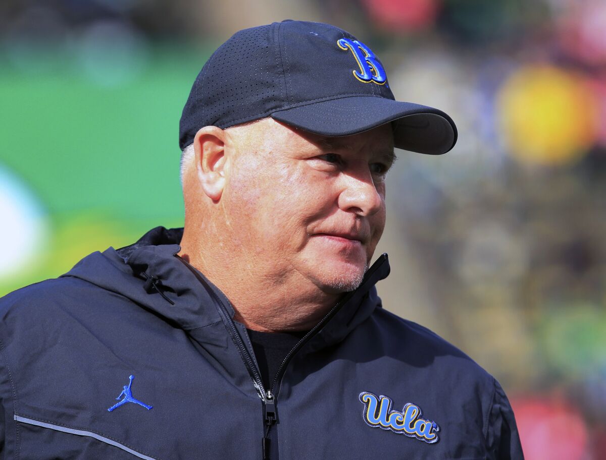 UCLA coach Chip Kelly watches warmups before a game at Oregon on Oct. 22, 2022.