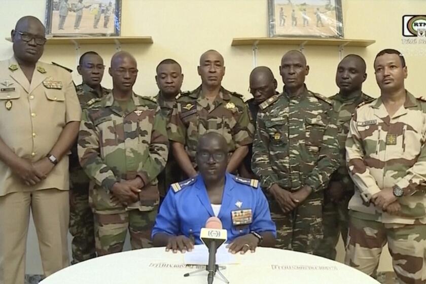 FILE - In this image taken from video provided by ORTN, Col. Maj. Amadou Abdramane, front center, makes a statement on July 26, 2023, in Niamey, Niger, as a delegation of military officers appeared on Niger State TV to read out a series of communiques announcing their coup d'etat. The U.S. is scrambling to assess the future of its counterterrorism operations in the Sahel region of Africa after the ruling junta in Niger announced it was ending military cooperation with Washington. (ORTN via AP, File)