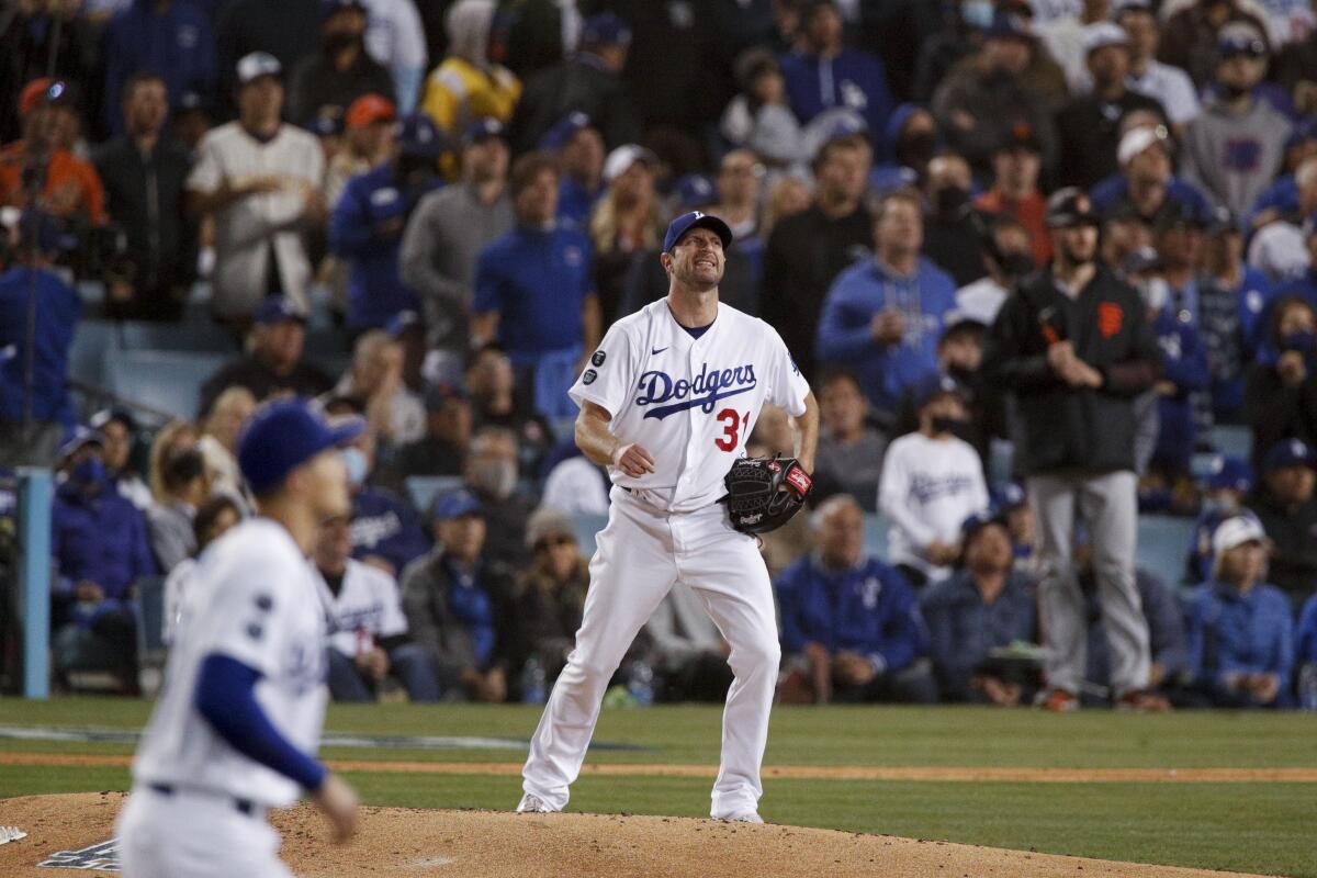 Dodgers starting pitcher Max Scherzer reacts after pitching to San Francisco's Steven Duggar.