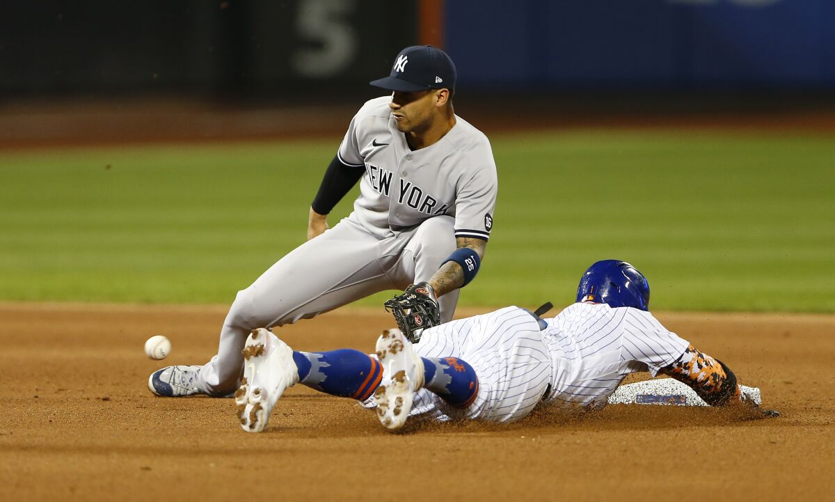 New York Mets' Jonathan Villar beats the throw to New York Yankees' Gleyber Torres for a stolen base during the fourth inning of a baseball game on Sunday, Sept. 12, 2021, in New York. (AP Photo/Noah K. Murray)