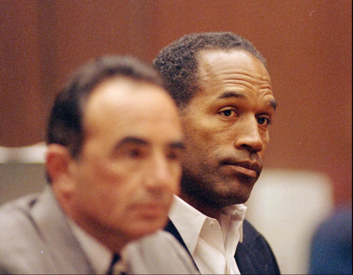 O.J. Simpson, right, sits with his lead defense attorney Robert L. Shapiro during a hearing in a Los Angeles courtroom on June 28, 1994. FX's "American Crime Story" has explored the trial.