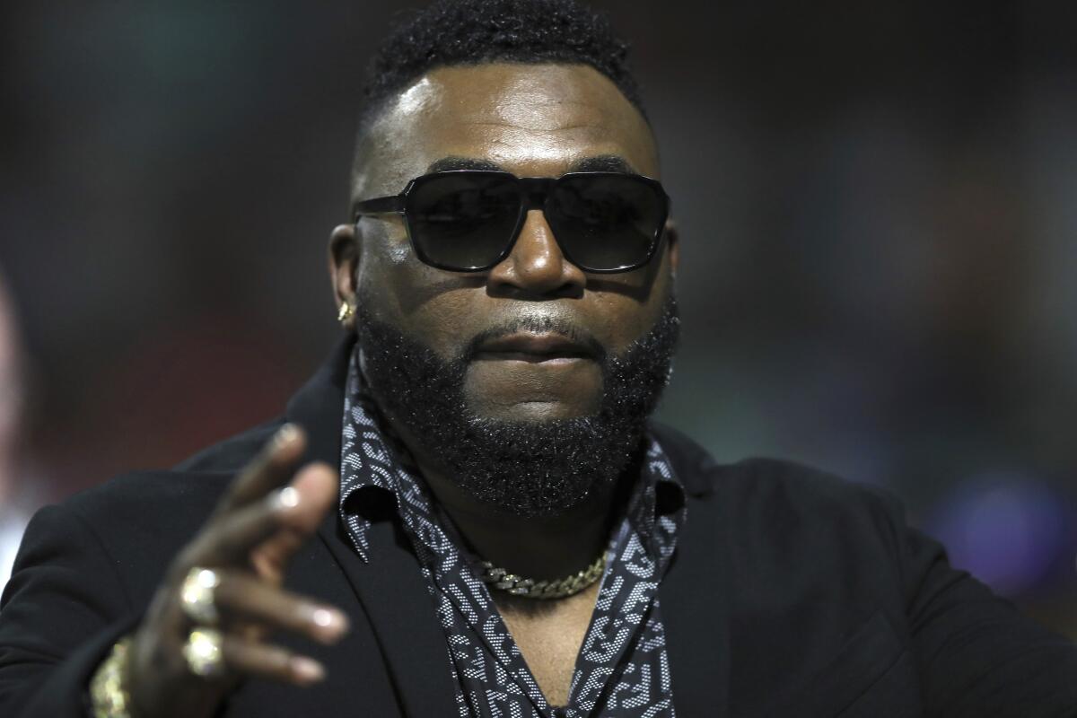 Retired Boston Red Sox player David Ortiz of the Dominican Republic, affectionately known as Big Papi, greets supporters before the start of a Caribbean Series baseball game between Dominican Republic and Puerto Rico, in San Juan, Puerto Rico, Wednesday, Feb. 5, 2020.(AP Photo/Fernando Llano)