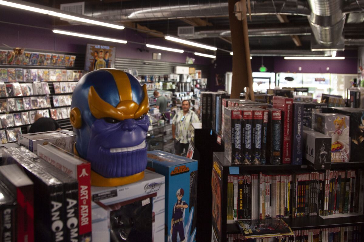 The Marvel villain Thanos keeps watch over the book section of Knowhere Games and Comics.