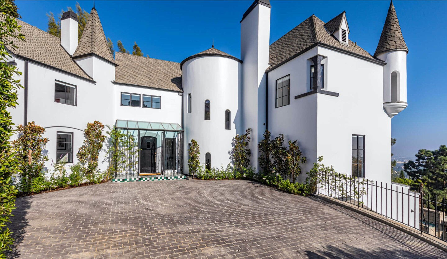 Built in 1926, the French Normandy-style home features turrets on the outside and modern, minimalist spaces on the inside.