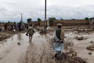 People are seen near to their damaged homes after heavy flooding in Baghlan province in northern Afghanistan Saturday, May 11, 2024. Flash floods from seasonal rains in Baghlan province in northern Afghanistan killed dozens of people on Friday, a Taliban official said. (AP Photo/Mehrab Ibrahimi)