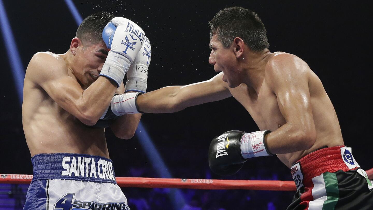 Jose Cayetano, right, of Mexico, lands a right to the body of Leo Santa Cruz during their featherweight fight at MGM Grand in Las Vegas on May 2, 2015.