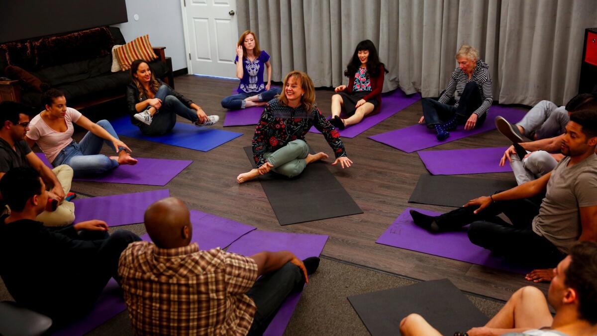 Acting teacher Elizabeth Mestnik, center, begins a class with breathing and stretching exercises.