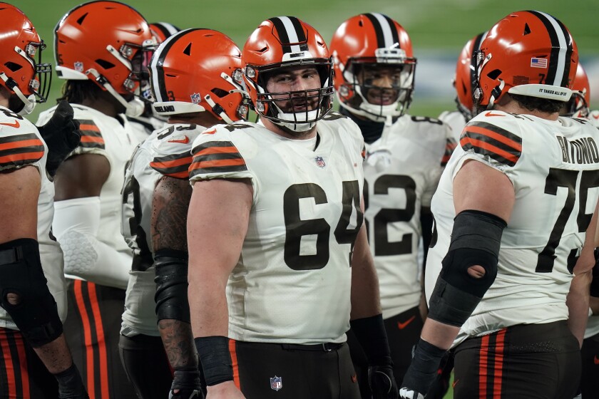 FILE - Cleveland Browns center JC Tretter (64) talks to teammates during the first half of an NFL football game against the New York Giants on Dec. 20, 2020, in East Rutherford, N.J. Tretter, the NFL Players Association president who has been pushing for daily COVID-19 testing all season, said he tested positive for the virus on Thursday, Dec. 23, 2021. (AP Photo/Seth Wenig, File)
