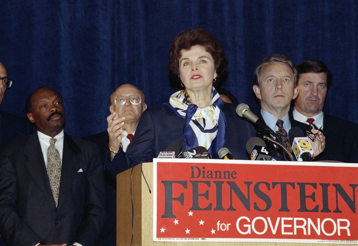 Flanked by four men, Feinstein makes an address from a lectern with a sign that reads "Dianne Feinstein for Governor."
