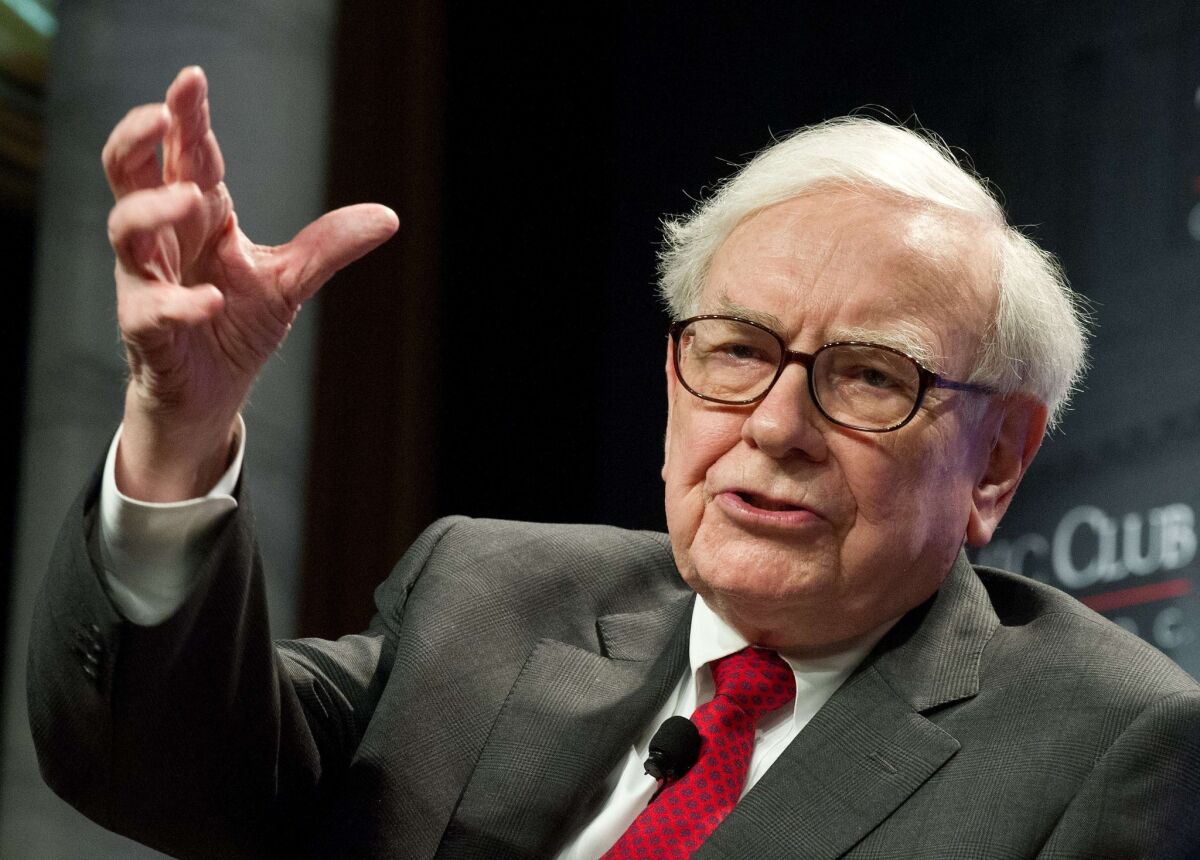 Warren Buffett, shown in 2012, is defending the $3-billion investment his Berkshire Hathaway is making in Burger King's acquisition of Tim Hortons and move to Canada.