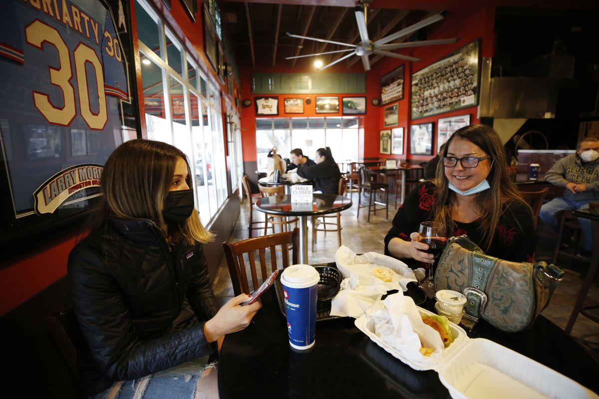 Two women dine inside a restaurant in San Luis Obispo.