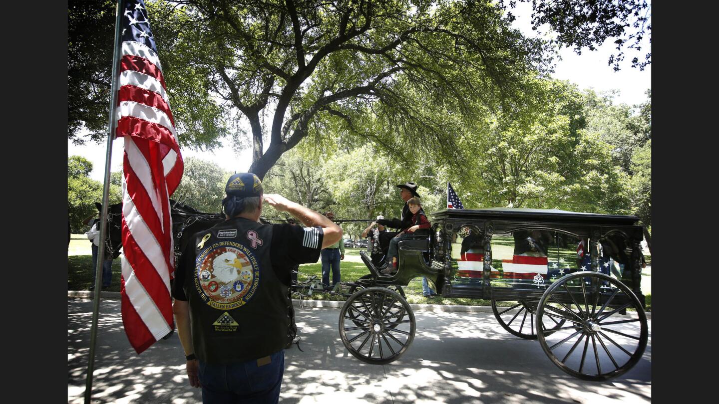 Magnus, the 8-year-old son of slain Dallas Police Officer Lorne Ahrens, rides with his father's coffin during the funeral Wednesday afternoon. Sr. Cpl. Ahrens and four other officers were killed in an attack during a Black Lives Matter protest on July 7.