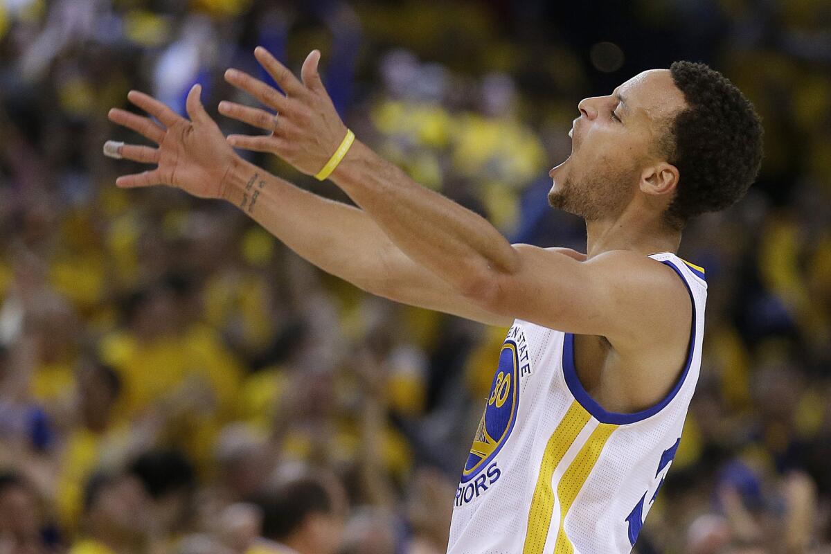 Warriors guard Stephen Curry reacts after scoring during the first half of Game 5 against the Memphis Grizzlies.