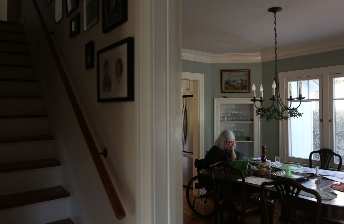 Missy reads on her iPad in the dining room of her home. "I live in a walking neighborhood," Missy says, "and there are lots of people walking their dogs or just walking around, and, it seems absolutely just amazing to me and I, I don't think I appreciated that enough."