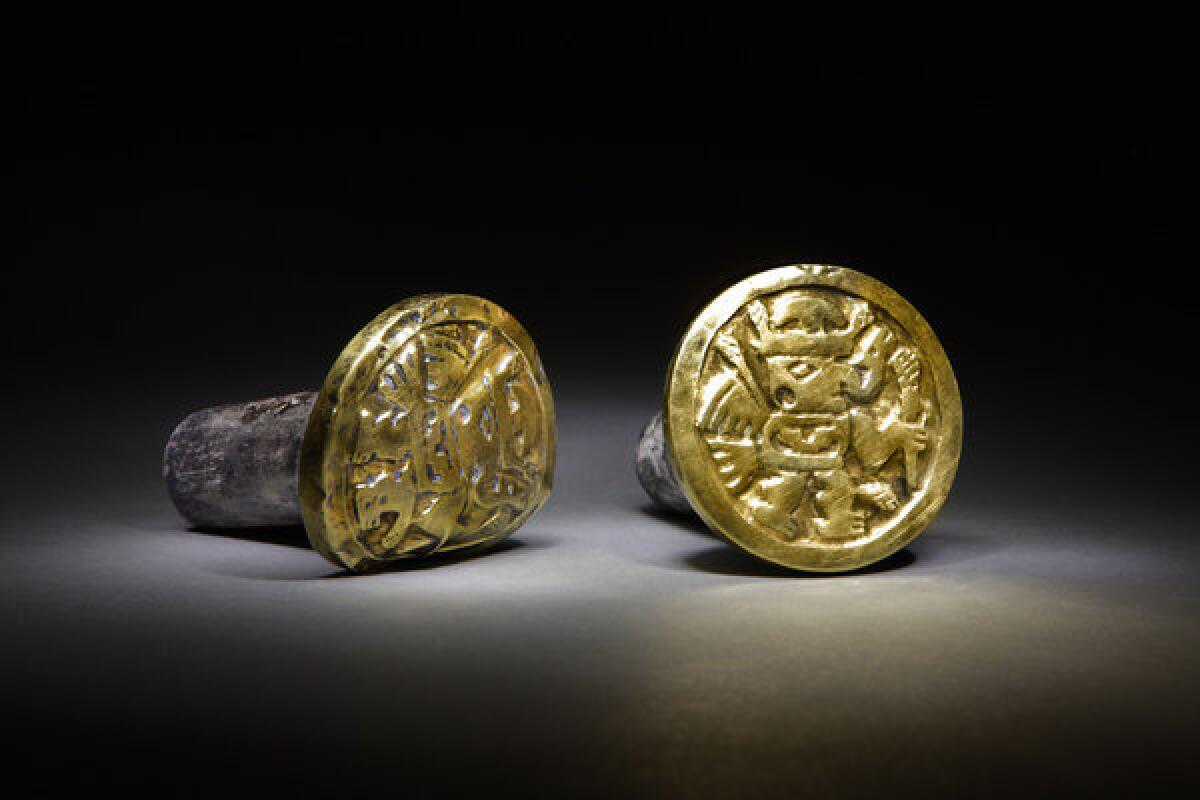 Archaeologists discovered these gold-and-silver ear ornaments, which a Wari woman wore to her grave, among more than 1,200 artifacts from a mausoleum in Peru.