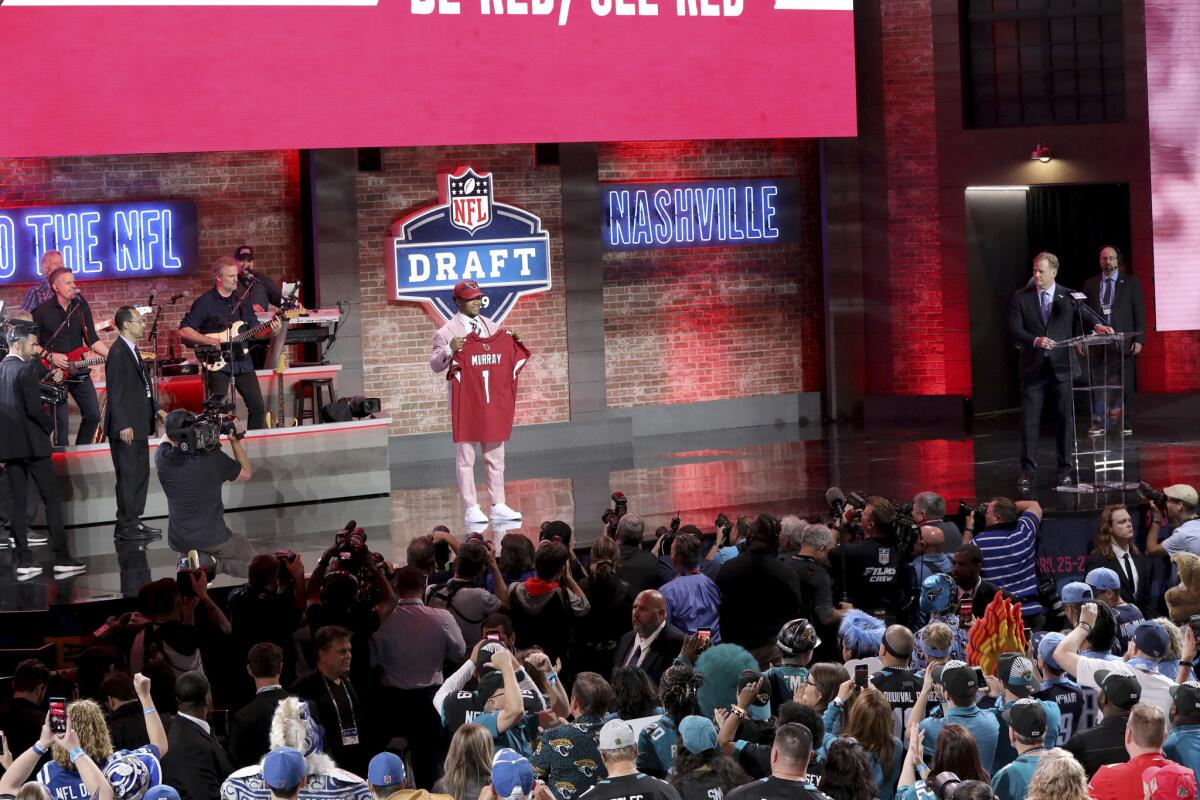 Kyler Murray poses with a jersey after being selected by the Arizona Cardinals with the first pick during the first round of the NFL football draft in 2019 in Nashville.