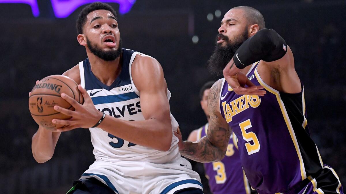Minnesota Timberwolves' Karl-Anthony Towns, left, posts up Lakers' Tyson Chandler during the first half at Staples Center on Wednesday.
