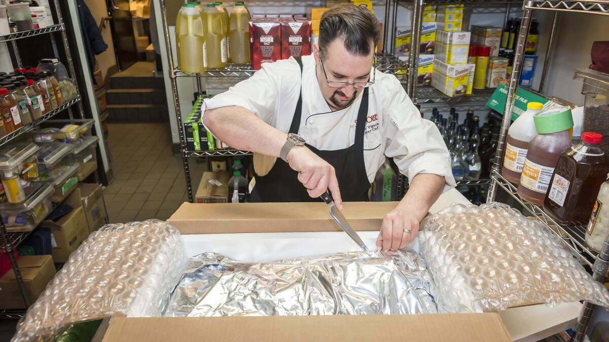 Corporate executive chef Michael Vignola opens a package of fish at his Strip House restaurant. He said all of his fish arrives at his Las Vegas restaurant within 16 to 18 hours of being caught in Hawaii. (Noah Feck)