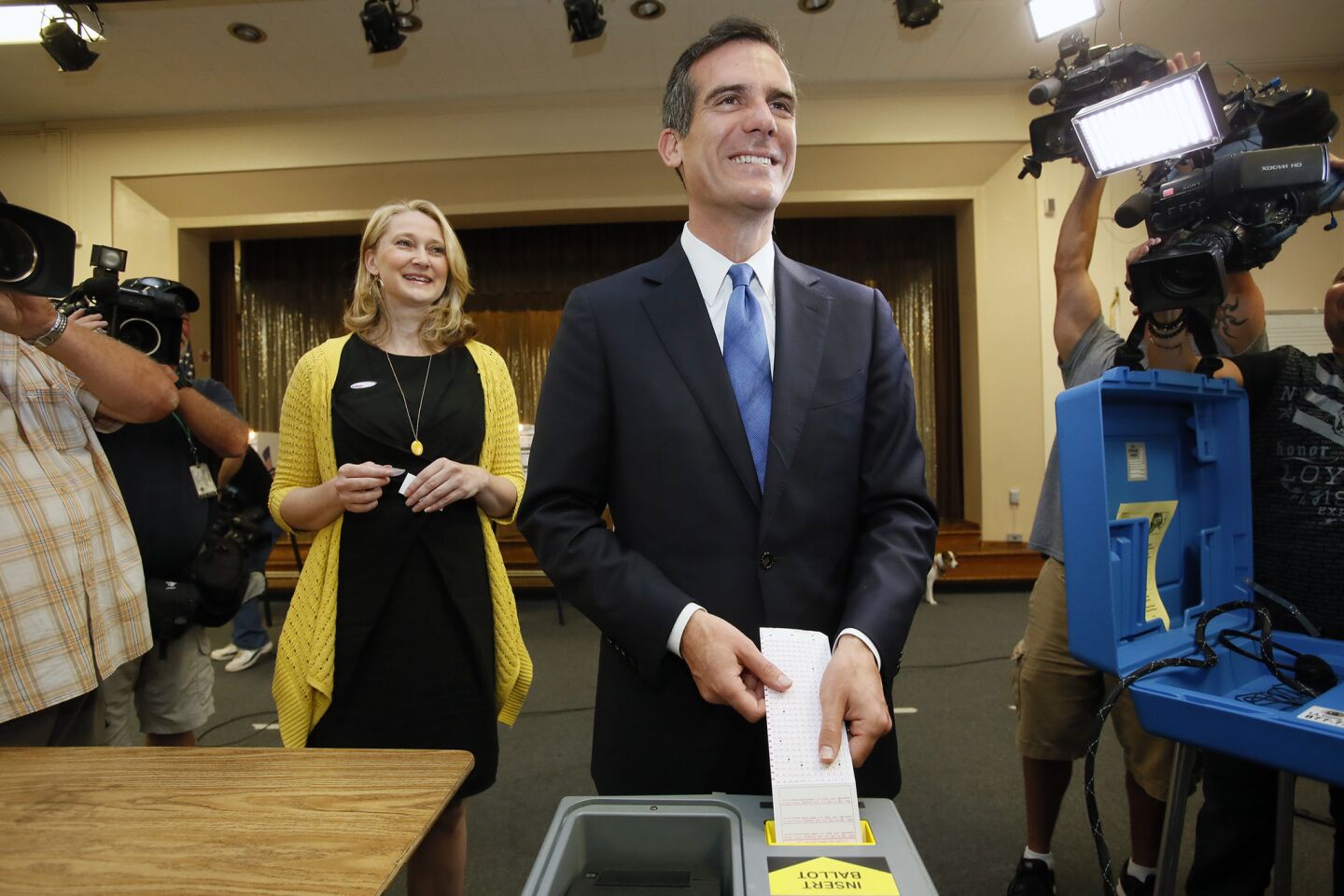 Mayoral candidate Eric Garcetti, with wife Amy Wakeland, casts his ballot at Allesandro Elementary School in Silver Lake.