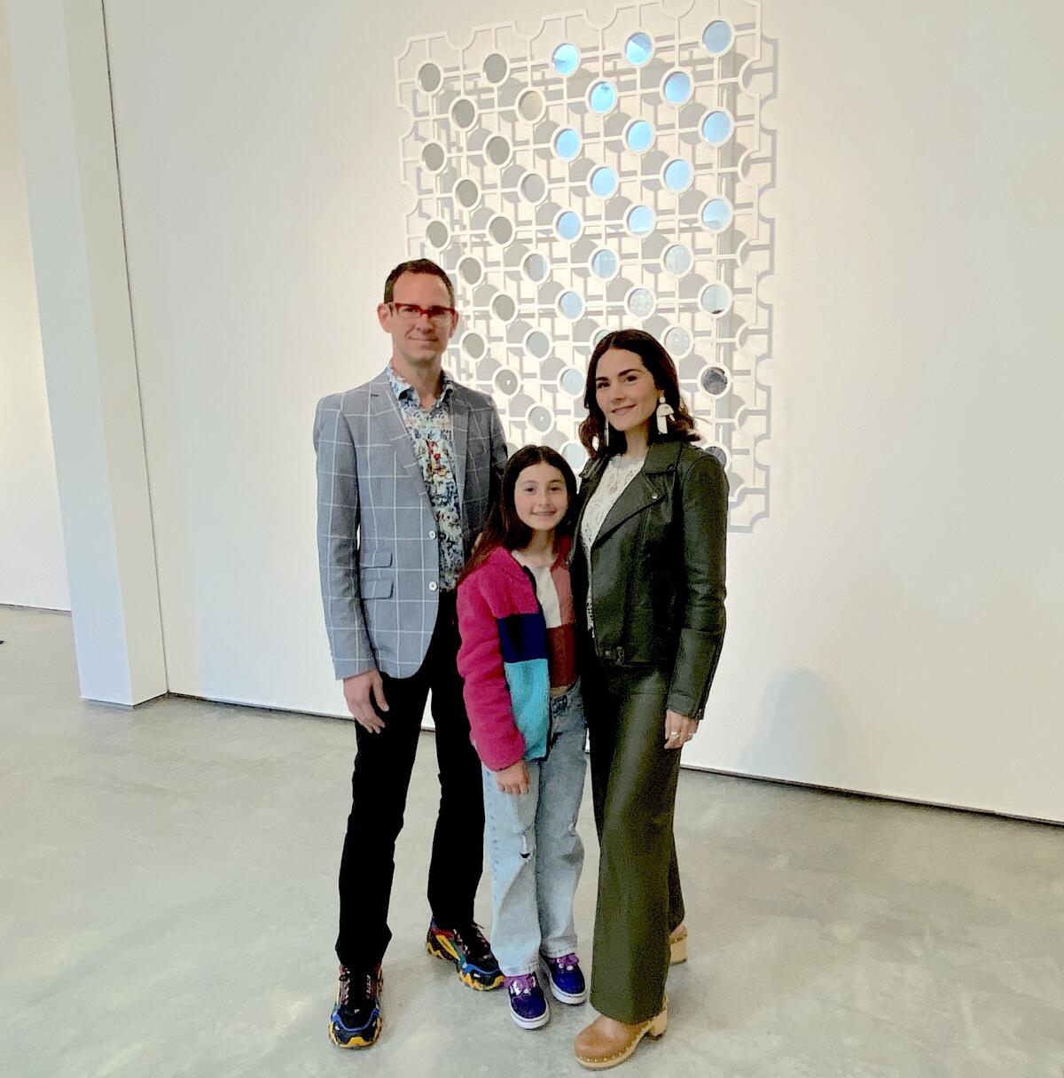 The artful Utt family: Andrew, filmmaker Carolina, and budding artist Olivia with one of Edra Soto’s sculpted pieces.